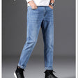 Jeanity Denim – Men's Slim Fit Straight Leg Denim Jeans – JeanityDenimMensSlimFitStraightLegDenimJeansPersonwearinglightbluejeansandblackshoesonagraybackground20260420115517jpg