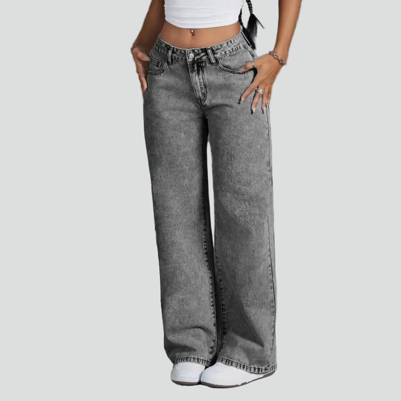 Gray wide-leg jeans worn by a person on a white background