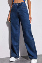 Person wearing blue wide-leg jeans on a plain background