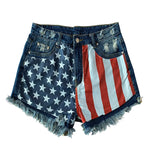 Denim shorts with American flag pattern on a beige background