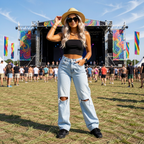 Jeanity Denim – Light Blue Ripped Jeans - High-Waisted Urban Style – JeanityDenimLightBlueRippedJeansHighWaistedUrbanStyleWomanposingatamusicfestivalwithcolorfulstageandattendeesinthebackground20260604071333png
