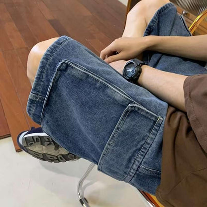 Person wearing blue jeans sitting on a chair with a wooden floor background