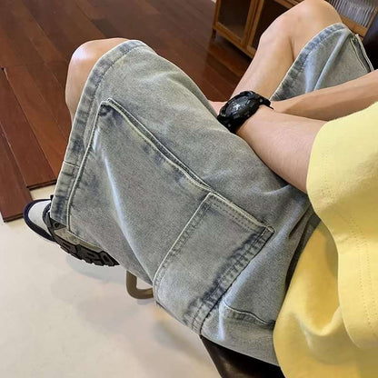 Person wearing light blue denim shorts sitting on a chair indoors.