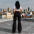 Person standing on a rooftop with a cityscape in the background