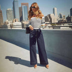 Jeanity Denim – Wide-Leg Denim Jeans – JeanityDenimWideLegDenimJeansWomaninastripedtopandwidelegjeansstandingonarooftopwithcityskylineinthebackground20260426132541jpg