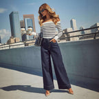 Jeanity Denim – Wide-Leg Denim Jeans – JeanityDenimWideLegDenimJeansWomaninstripedtopandwidelegjeansstandingonarooftopwithcityskylineinthebackground20260426132547jpg