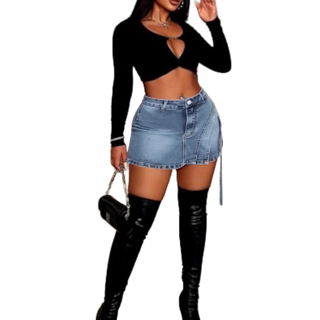 Jeanity Denim – Women's Mid-Rise Distressed Denim Skort – JeanityDenimWomensMidRiseDistressedDenimSkortWomanwearingablacklongsleevetopanddenimskirtwithblackkneehighbootsinanindoorsetting20260221071631jpg