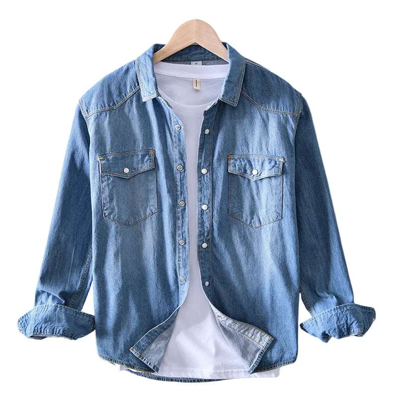 Blue denim shirt on a hanger against a white background