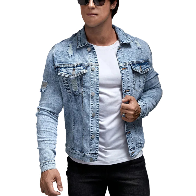 Person wearing a denim jacket over a white shirt with a camouflage-patterned background