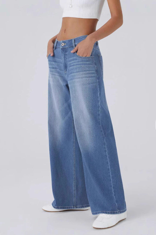 Person wearing blue wide-leg jeans on a white background